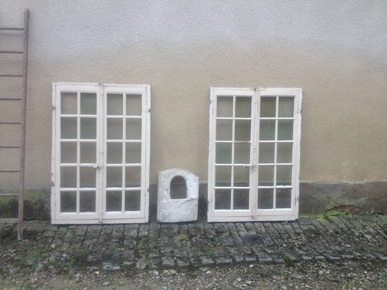 A great pair of double-windows handcrafted in wood, early 19th century.
From Paris, France. Great condition.
They can also be used inside as bookcases doors.

  
