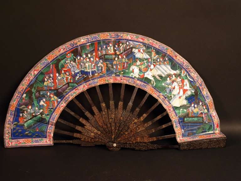 A very unusual Chinese export Cantonese telescopic fan, with tortoise shell sculpted sticks sliding into the ribs to make the fan smaller to carry it. It is painted recto with noble men attending a theater scene with white horses and verso with