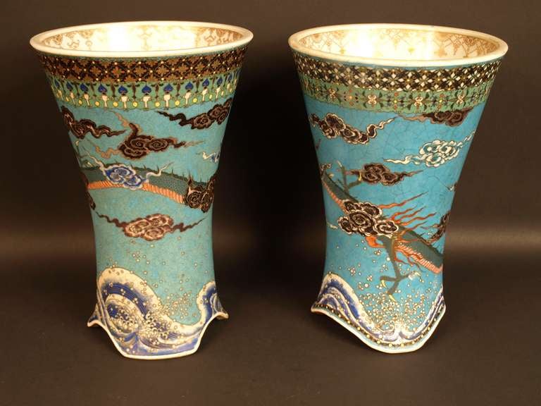 Two slightly different cloisonné on porcelain vases by Takeuchi Chubei representing dragons flying over waves as a pair .

Height: 25 and 24,5 cm.
Japan, early Meiji period, 19th century