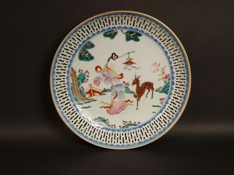 A Chines Famille Rose reticulated dish , Qianlong period (1736-1795).
 Painted to the centre with He Xiangu, the only female immortal, represented with a deer (symbol of wealth) beside a pine tree and flowering bushes for longevity.

27.2 cm