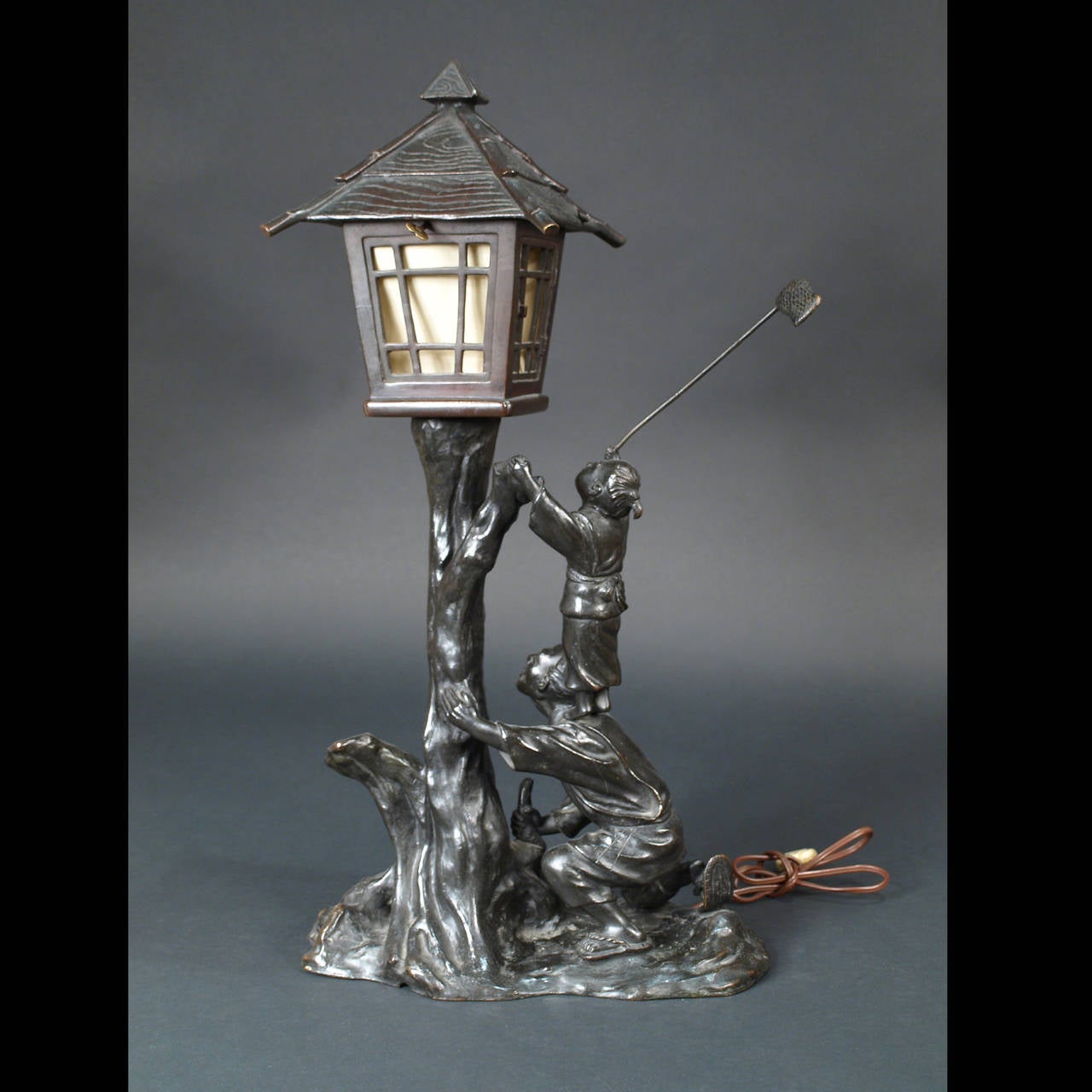 This is a very original bronze lamp representing a little boy trying to catch a bird.
Japan, early 20th century.