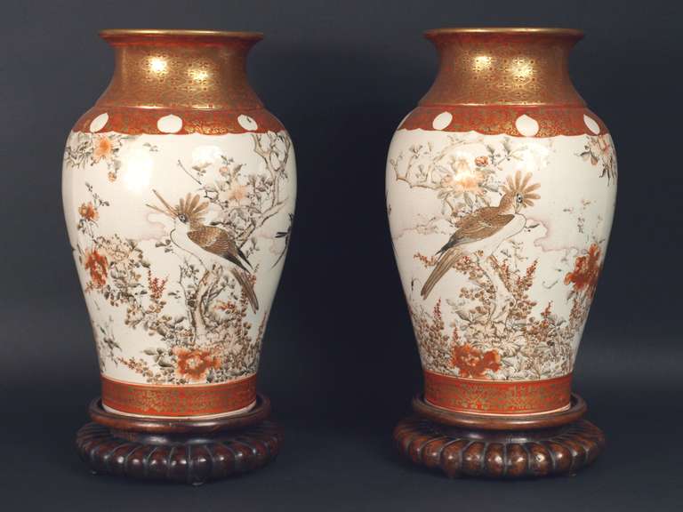 A beautifull pair of Japanese hand painted Kutani vases, decorated with iron red and gold with birds and flowers with two japanese wood stands.
Signed Great Japan Nenzan?Do Sei
pierced for electricity. They would be great lamps.
Meiji Period,