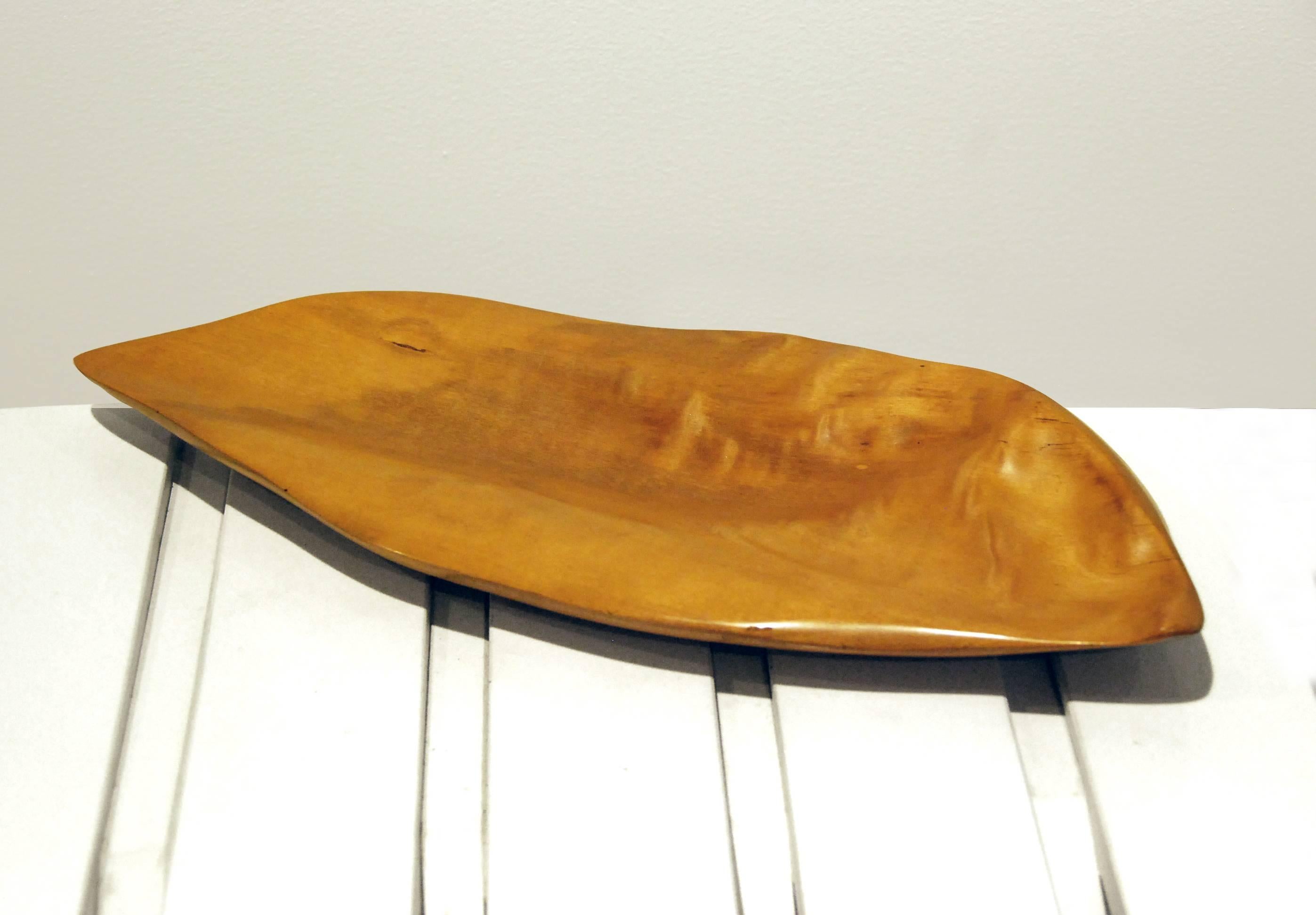 This sculptural tray was made by Alexandre Noll from carved sycamore in 1965. 

French designer Alexandre Noll perceived the creation of furniture to be a true art form. All his objects were handmade and unique artifacts. Noll’s approach to