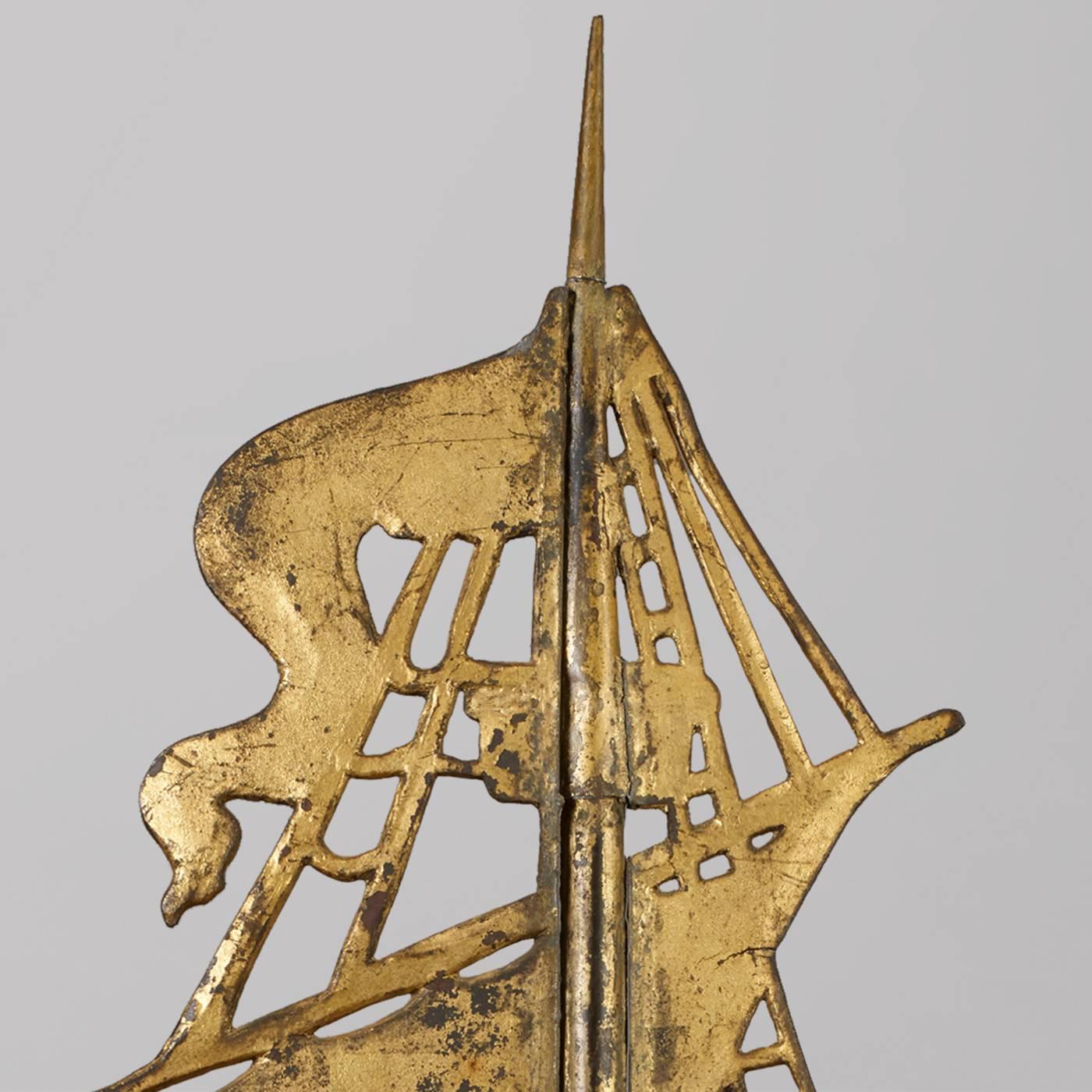 This American ship weathervane is made in copper with cast iron sails and upper portion. The piece still retains its original gilt and is probably made in New England, possibly Cushing and White, Waltham, Massachusetts, circa 1880. 

Condition: