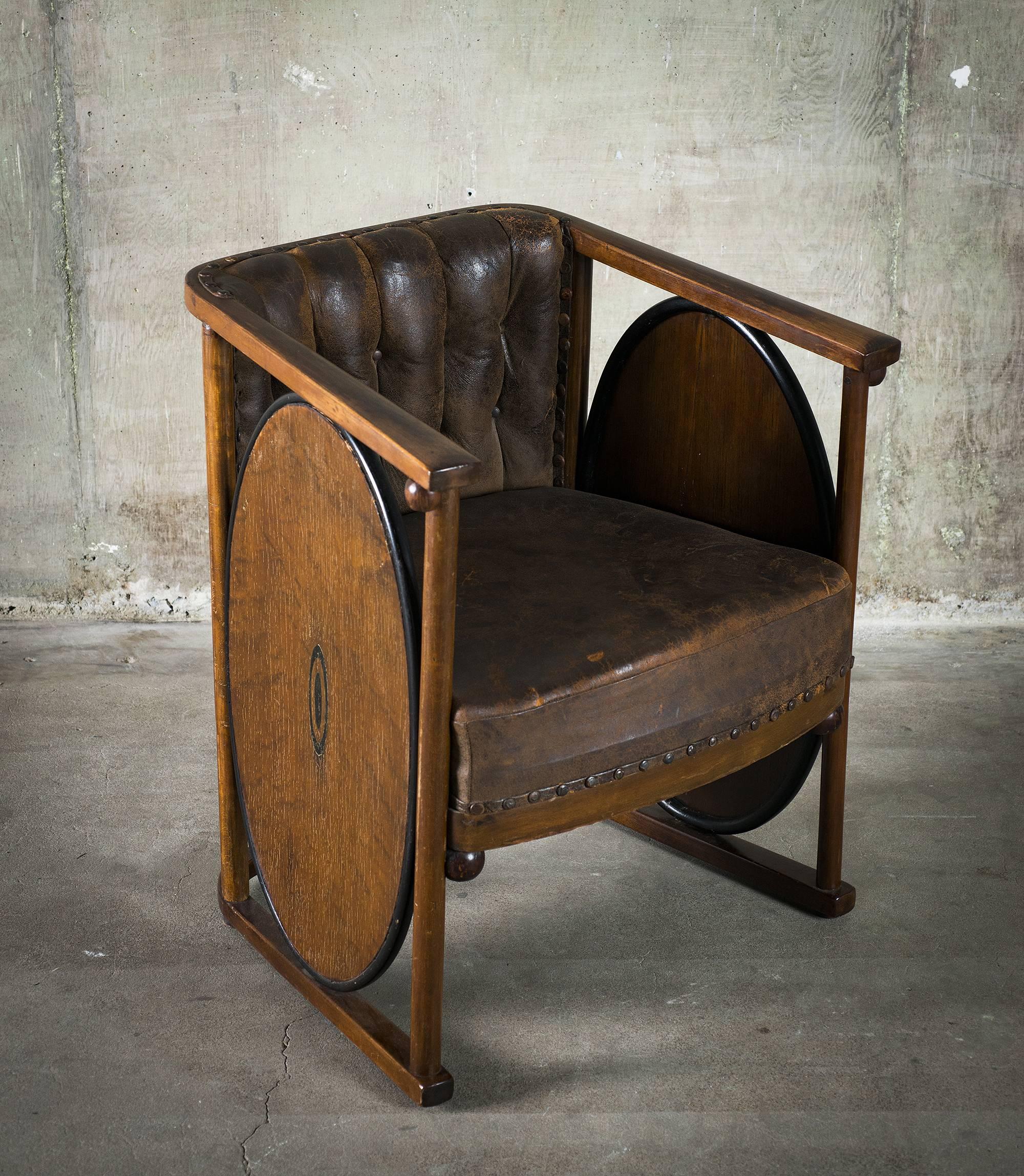 This rare and unusual armchair inlaid made of bent beech and plywood, marquetry, leather, brass inlays is attributed to Koloman Moser or Josef Hoffman, J&J. Kohn, Model No. 422, Austria, circa 1907.

Condition distressed, vintage, wear to