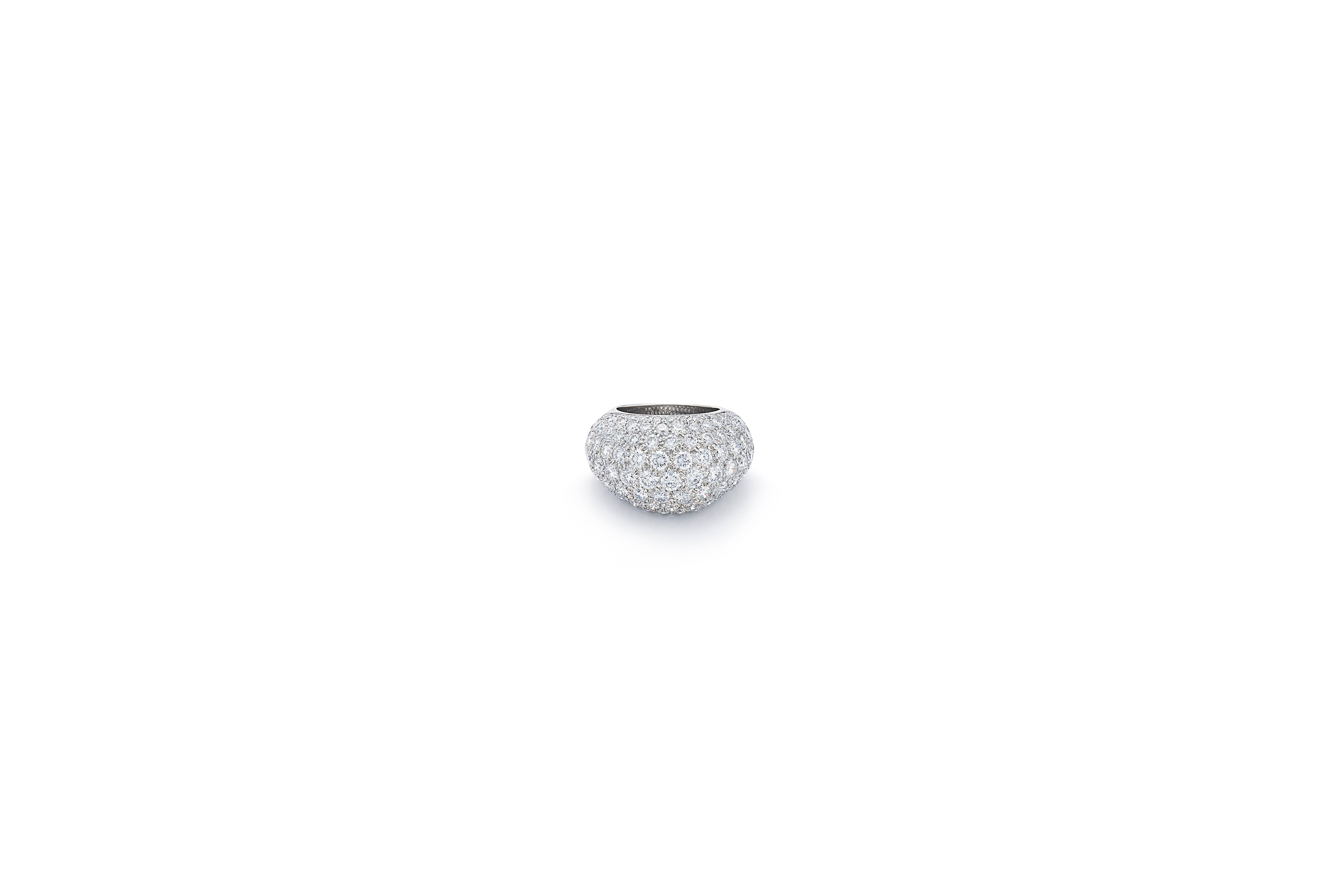 This very wearable and chic ring is designed as a pave-set diamond dome, mounted in platinum and with French assay marks, circa 1950s. The total weight of the diamonds is approximately 5.75 carats and is ring size 5.5.