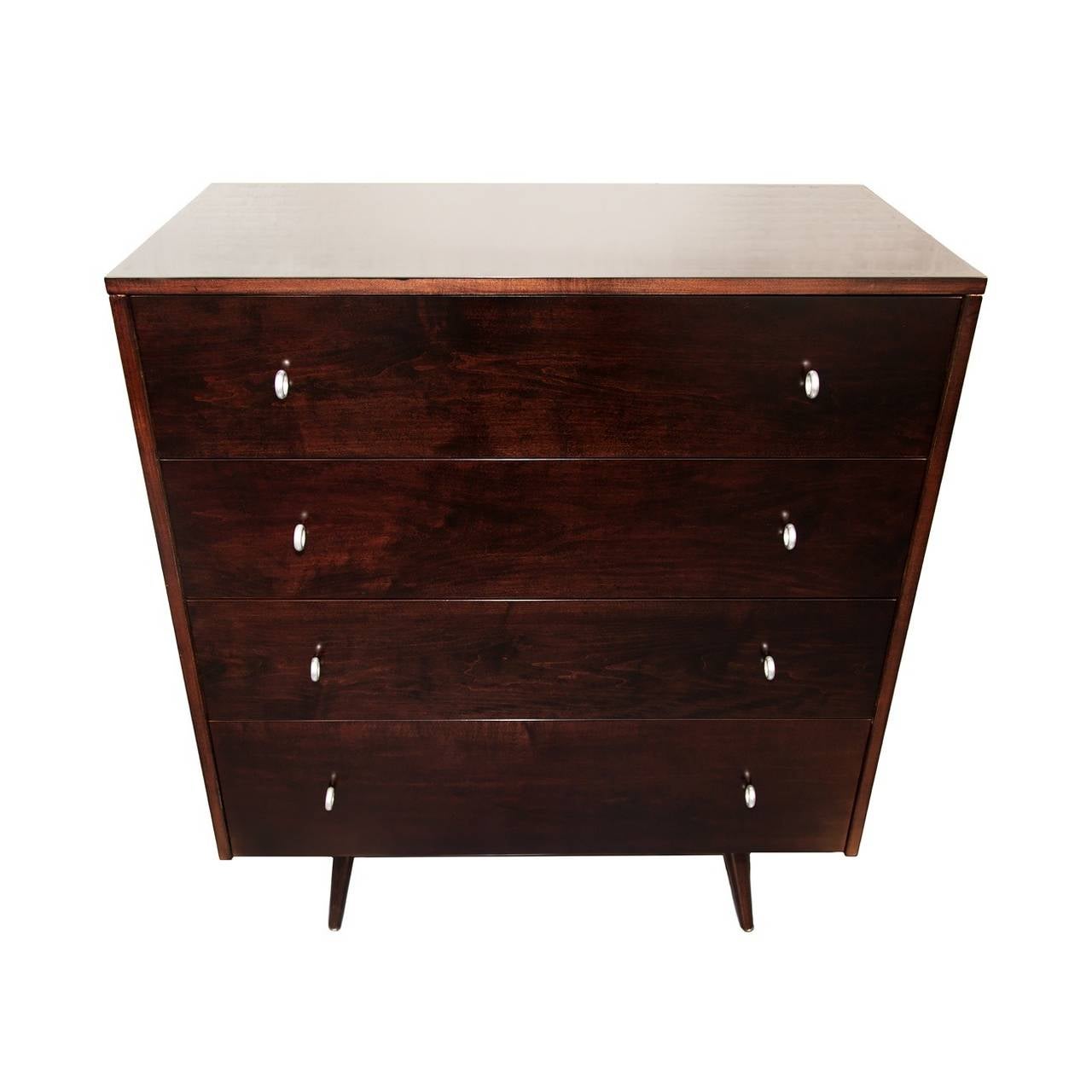 A modernist four-drawer Paul McCobb Planner Group chest or dresser. Newly restored and refinished in a dark walnut stain. Satin silver pulls.
