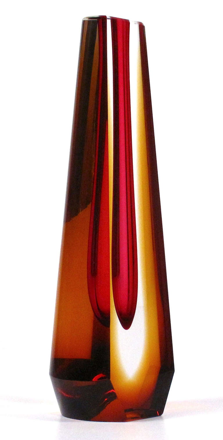 A sculptural glass vase by Pavel Hlava. An deep pink teardrop is suspended in an amber and clear glass form.The inner tubular core can be used as a vase, but this is more of a sculpture. Maker's mark on bottom.