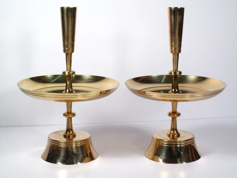 A lovely pair of brass candleholders by Tommi Parzinger. Maker's mark on bottom.