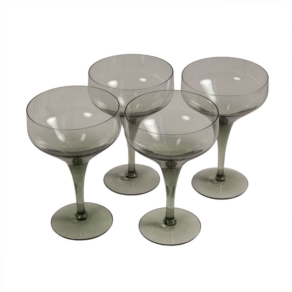 A set of four midcentury smoky grey cocktail or champagne glasses by Sven Palmqvist for Orrefors. Three sets of four are available.