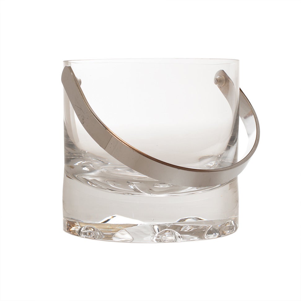 A modernist vintage Kosta ice bucket with a chrome handle and an incised design on the bottom. Original sticker intact.