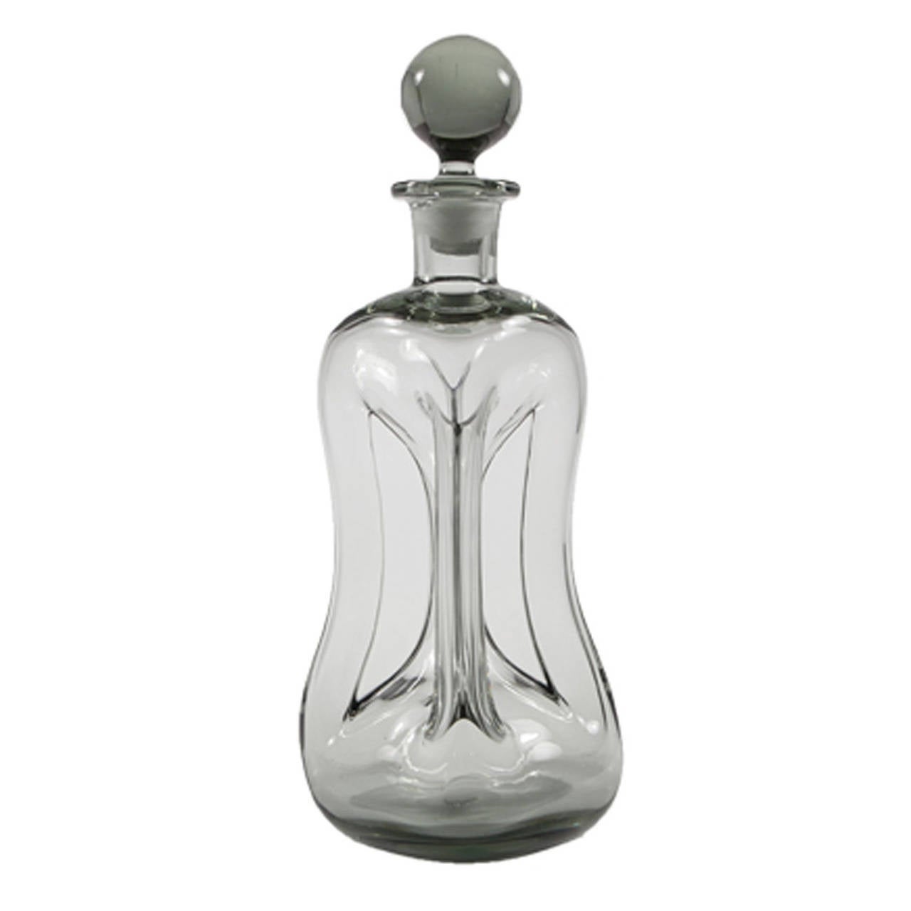 A smoky grey sculptural glass decanter with ball stopper.