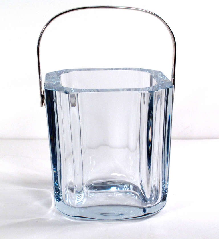A lovely crystal ice bucket with a slight blue tinge and silver-plated handle by Strombershyttan. Signed and numbered.