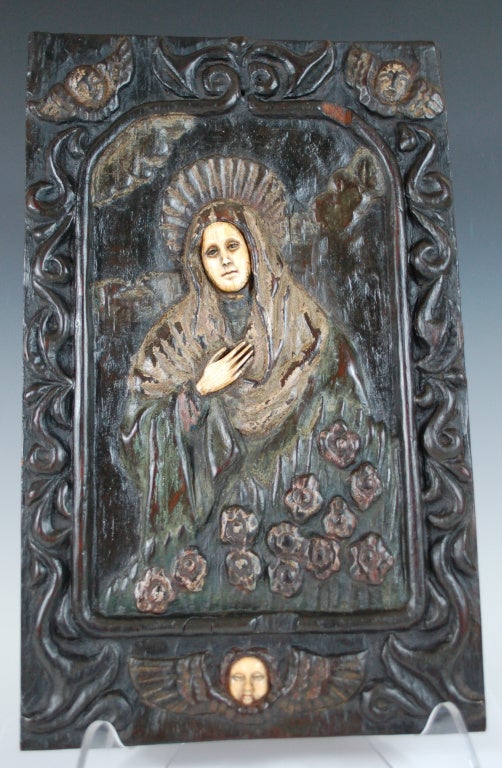 Wonderful 18th C Spanish Colonial Retablo. Carved dark wood and polychrome with inlay.  Mary's face and hand as well as the angel are inlay.  Probably made in Manila but could also be Mexican. Has great patina. some remaining paint 14