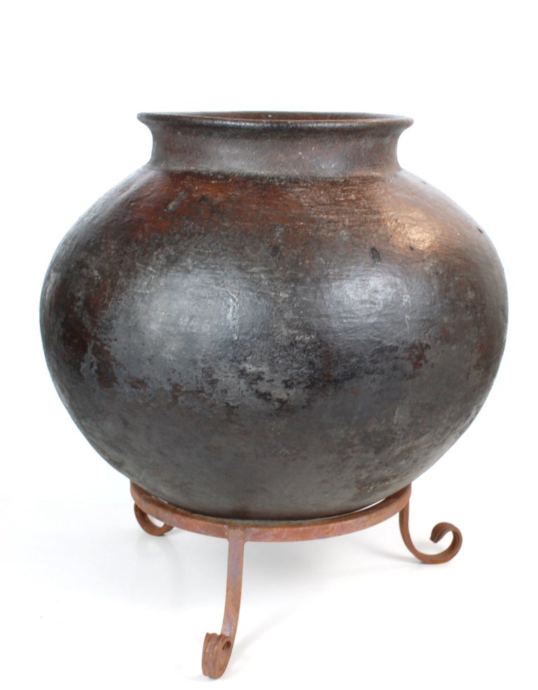 An amazing utilitarian antique pot used for cooking. This is a huge heavy and resistant piece.  Not tourist ware this is a unique and gorgeous hand coiled utilitarian pot of enormous proportions.  Used likely for cooking for an small community,
