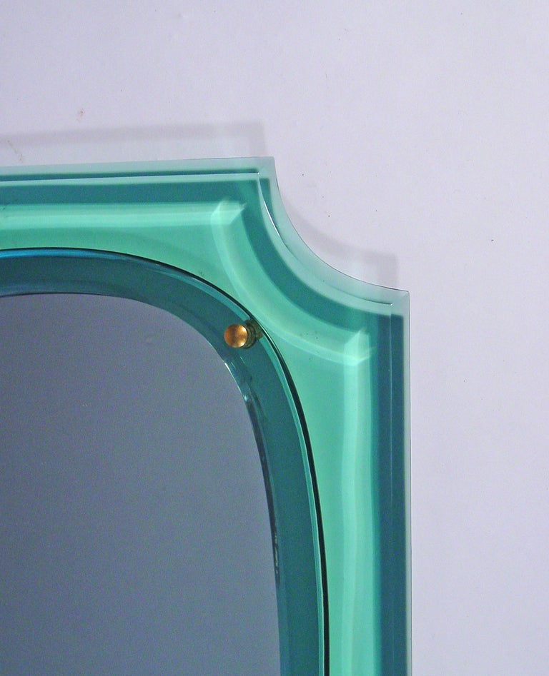 A beautiful Italian wall mirror with a light green faceted glass frame