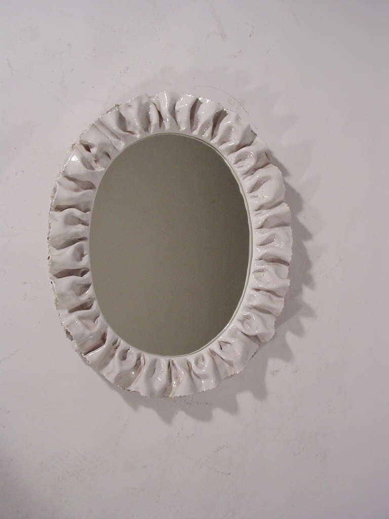A magnificent glazed ceramic wall mirror, can be hanged horizontal or vertical
Reminiscent of works by Fausto Melotti.
La Farnesiana Italy