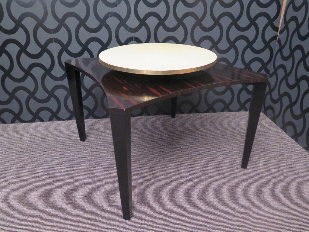 Couple of side tables, very elegant and stylish, top covered in parchment and macassare, black lacquered legs. Enhances a brass edge.