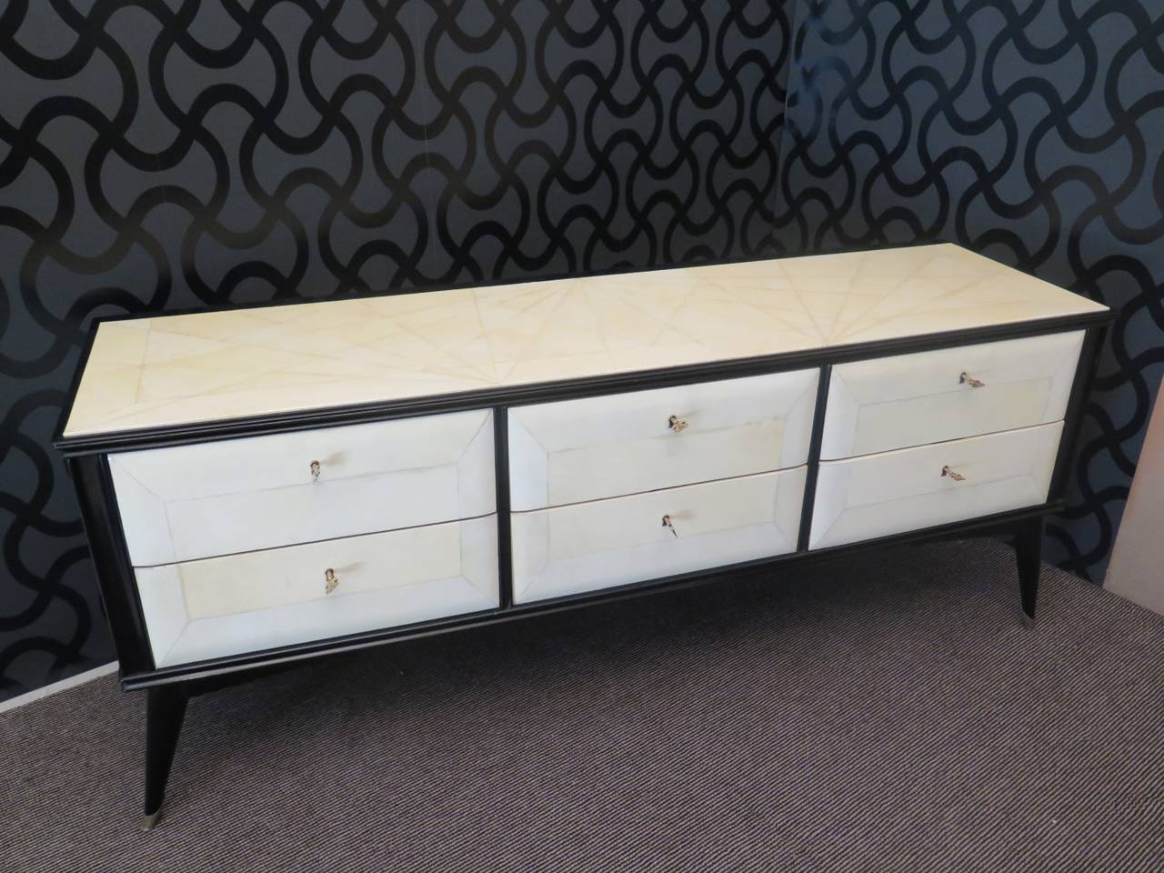Very peculiar dresser 1950s, all covered in parchment, with lacquered parts in black. Very nice shape, low and long, with six drawers; just for the bedroom.