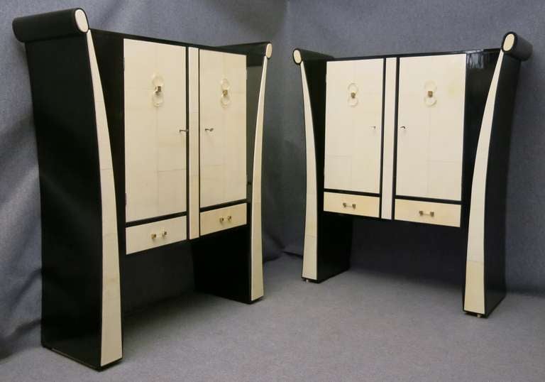 Particular pair of high sideboards, black lacquered with doors in parchment, and beautiful glass gilded handles and brass. Very elegant, the sides with these long commas.