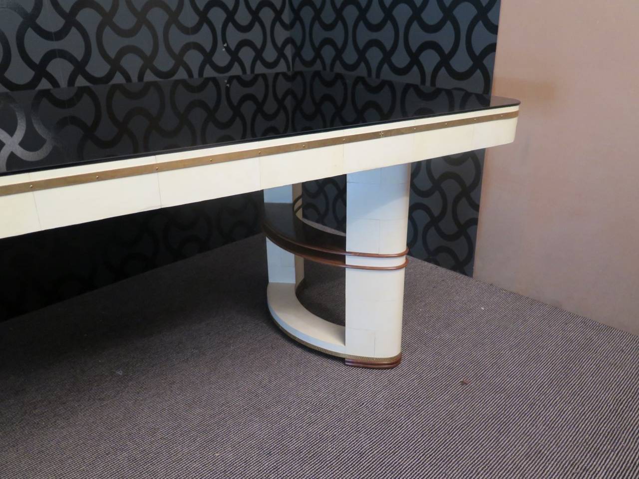 Italian Art Deco table. Composed of three materials, wooden structure then glass and parchment leather. The tabletop is covered by a black glass, well rounded on the corners, it does not have frames around it but it forms a sharp edge with the edge.