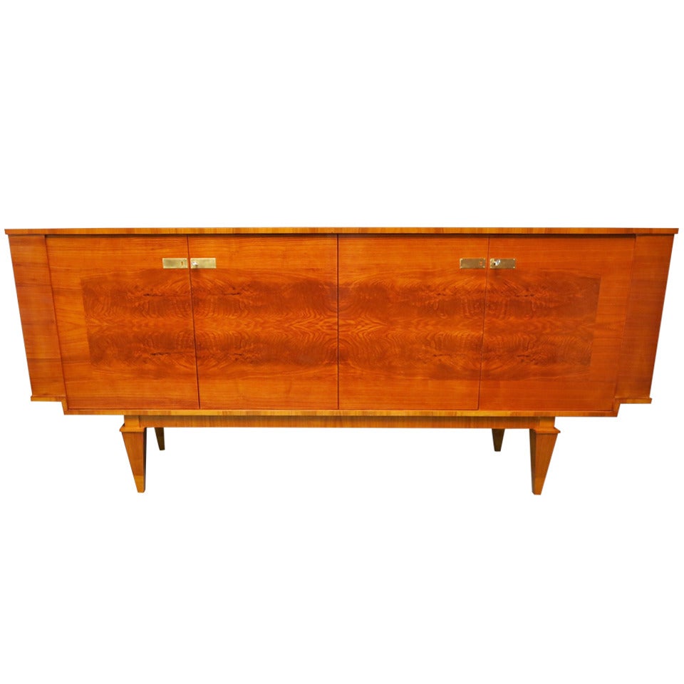 Long sideboard Art Deco veneered in cherry and ash, four doors, very capacious, linear but very elegant. With this very hot color is a piece to put absolutely at home. Note its small pyramid-shaped feet, the design of the veneer on the four doors,
