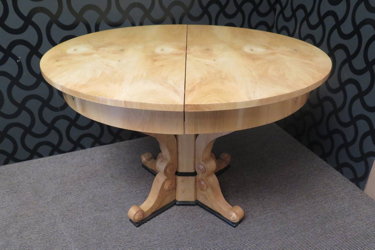 An important Biedermeier table, with a big round top and a very particular leg. The tabletop is veneered with a beautiful bleached walnut. The central leg is formed by a central massive of walnut and by four walnut wood lacquered legs. The open