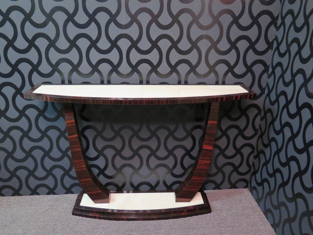 Italian Art Deco Console, all veneered in Macassar ebony and parchment leather. Composed of two top, one above and one below joined by two curved legs. The upper top has an external frame veneered in macassar ebony and a central part in parchment