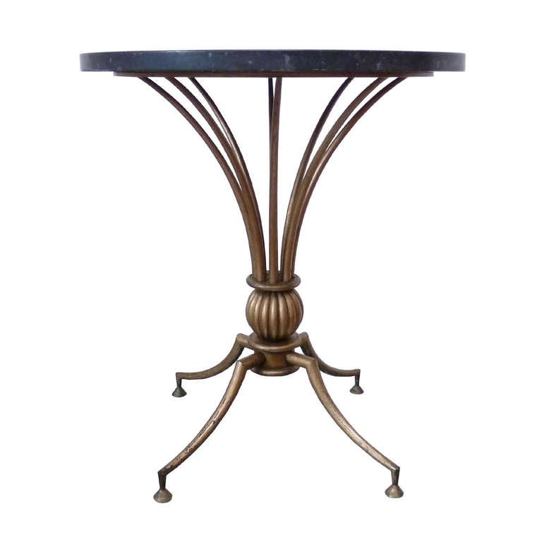 Neoclassical side table made ​​of gilded iron with brass details and black marble. Original condition. Great design of Arturo Pani