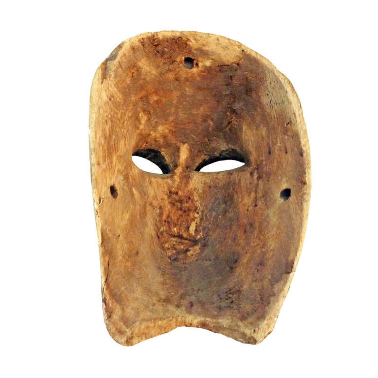 Mexican Mask of the first half of the 20th century, carved in colorin wood with polychrome finish in beige and black, with paint loss and cracking for years.