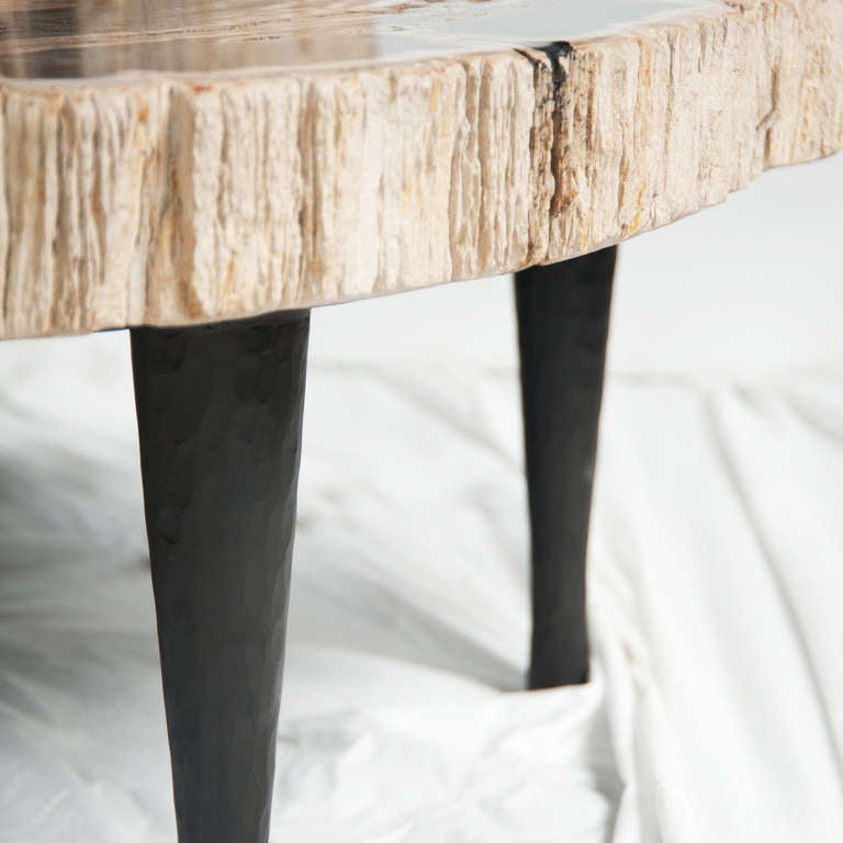 A set of three matching petrified wooden tables.