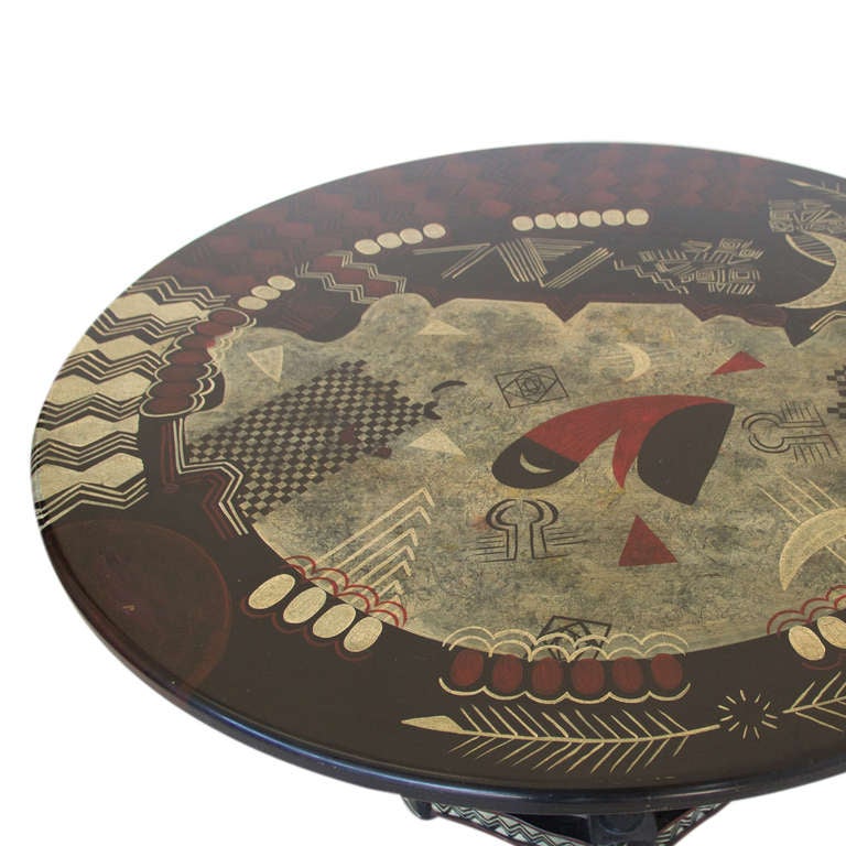 A wooden table with painted detail inspired by the Aztecs.