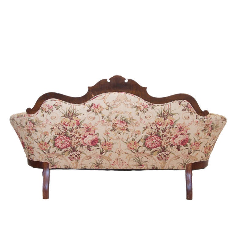 A settee in the queen Ann style covered with a Ralph Lauren floral motive fabric