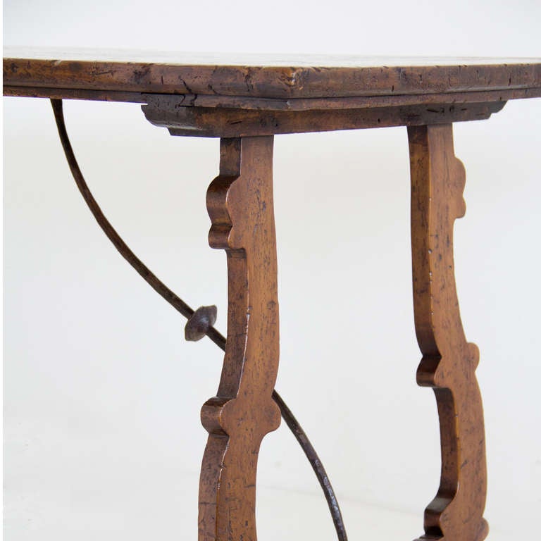 Replicas of lyre leg walnut trestle tables with an iron stretcher.