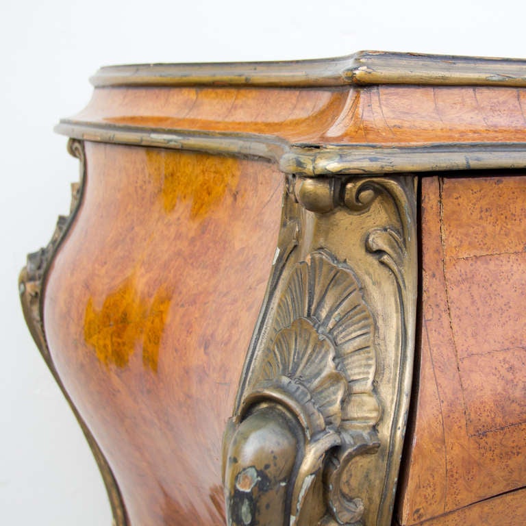 A bombe Louis XV style burl wood commode with nice bronze details/handles; in an elegant Louis XV style.
Made in the 1940's.