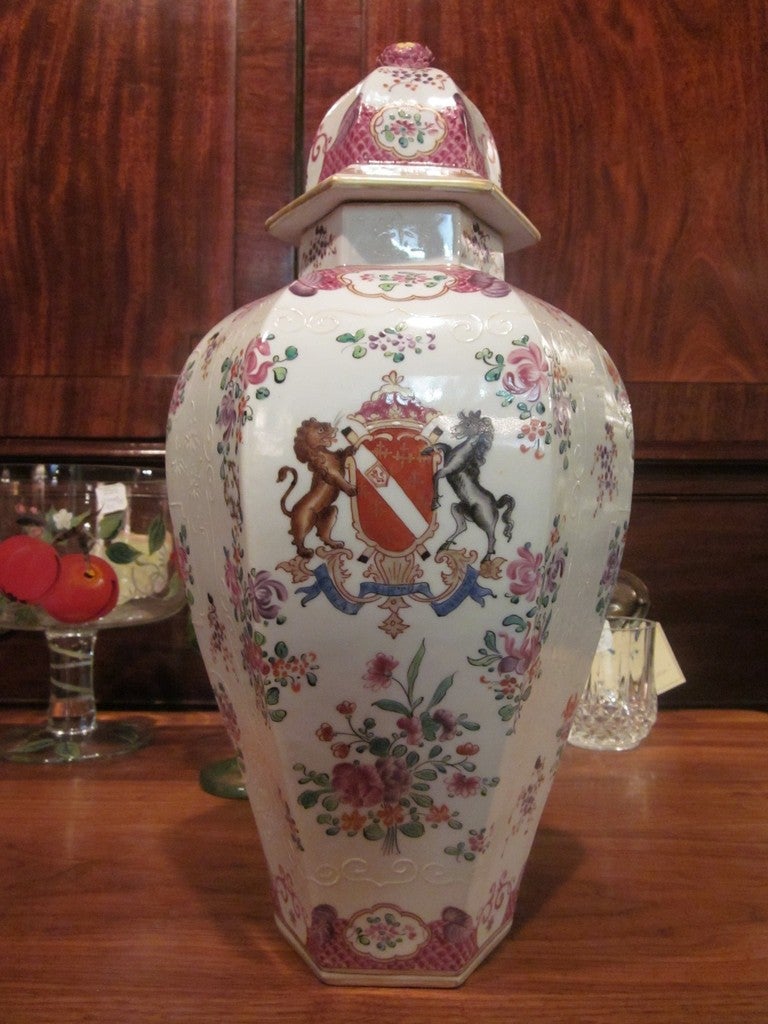 A porcelain jar with cover done in a French floral design surrounding a crest held by a lion and a horse with the inscription 'Sola Virtus Invicta' = Bravery Alone is Invincible.