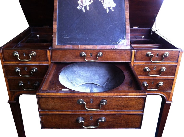 Late 18th century mahogany English Beau Brummell dressing table with original bowl, compartments, mirror, hardware and casters.
