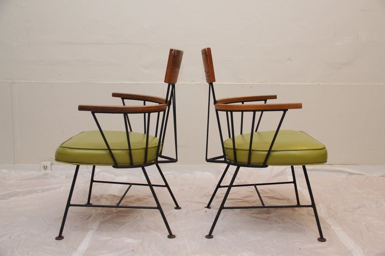 This is a unique and fun set of 5 Paul McCobb dining chairs. The chairs are ash wood with wrought iron and green vinyl seats.These are being sold separately so could also be great accent chairs.