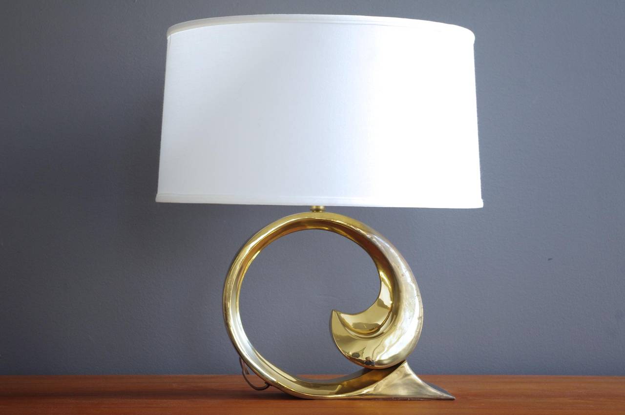 A polished brass table lamp with sculptural scroll form by Pierre Cardin, circa 1970s. 

Shade not included.