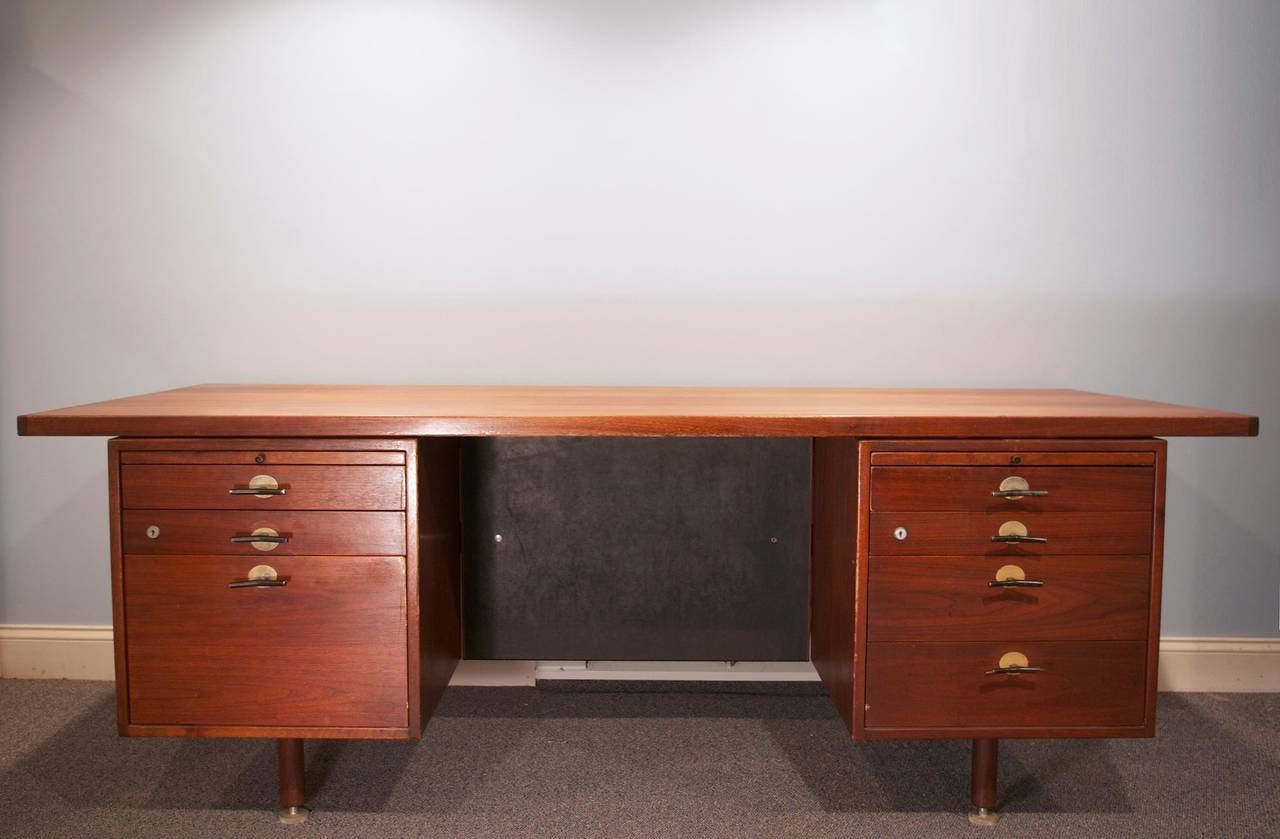 A large and handsome executive desk constructed of solid walnut with 