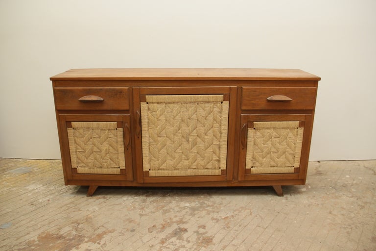 Cedar wood cabinet with beautifully woven rush-front doors. Designed by Edmond Spence for Mexican Modernist furniture company, Industria Mueblera. This piece was procured by Reside from its original owners, who purchased in it Guadalajara, Mexico in