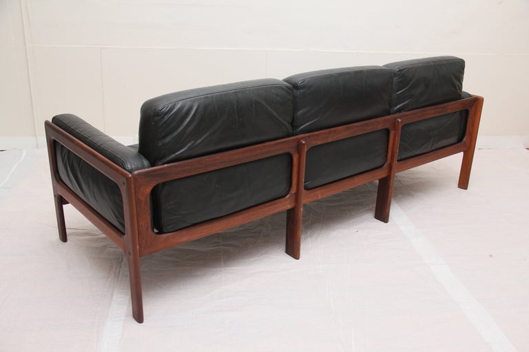 1969 Komfort Mobler Rosewood and black leather 3-seater sofa.  Beautiful wood grain and high quality leather.