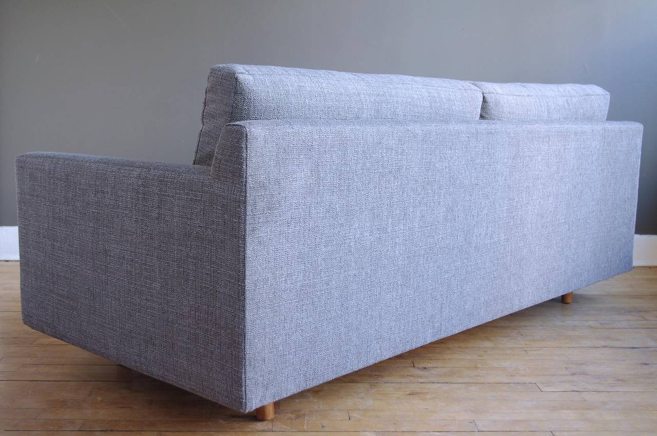 A handsome and compact sofa designed by Harvey Probber, circa 1960. Down-filled bench cushion offers an extremely comfortable seating experience. Cylindrical bleached mahogany legs. 

Recently upholstered in a durable, gray bouclé and in