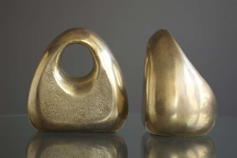 A pair of sculptural orb bookends designed by Ben Seibel for Jenfred-Ware, ca. 1950. Constructed of a cast metal alloy with applied brass finish. In very good condition with original manufacturer's label intact. 

A wonderful organic shape.