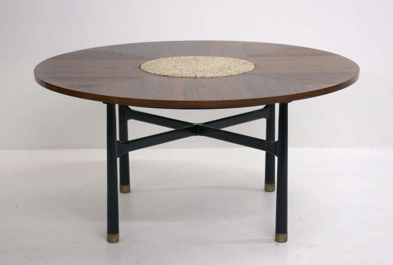 A game table designed by Harvey Probber, ca. 1960. Consisting of a walnut, match grain top with terrazzo stone insert supported by an ebonized wood base. Legs are finished with simple brass feet. 

A sleek and nicely proportioned piece that could