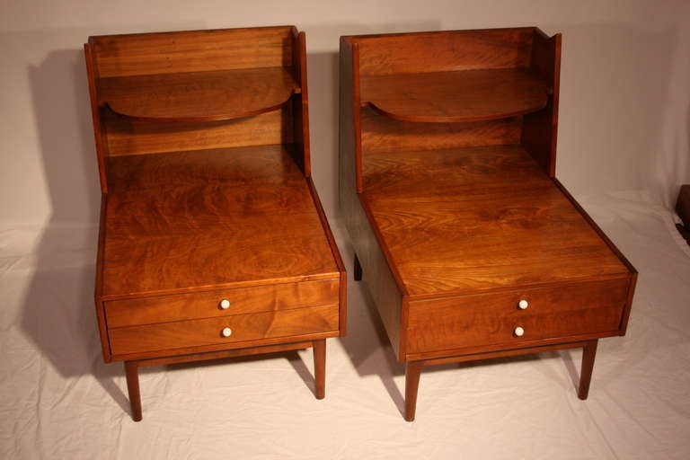 Unbelievable pair of figured walnut nightstands by Kipp Stewart for his Drexel Declaration collection. Top shelf floats above two drawers with original porcelain ball pulls. The tables are finished on the back side so could also be used as