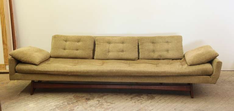 This gondola style sofa is classic Adrian Pearsall at his best.  The sculpted cradle base is walnut.  The beautiful form and spectacular lines create a very dramatic effect.  This is a long, comfortable sofa that one can really stretch out on and is