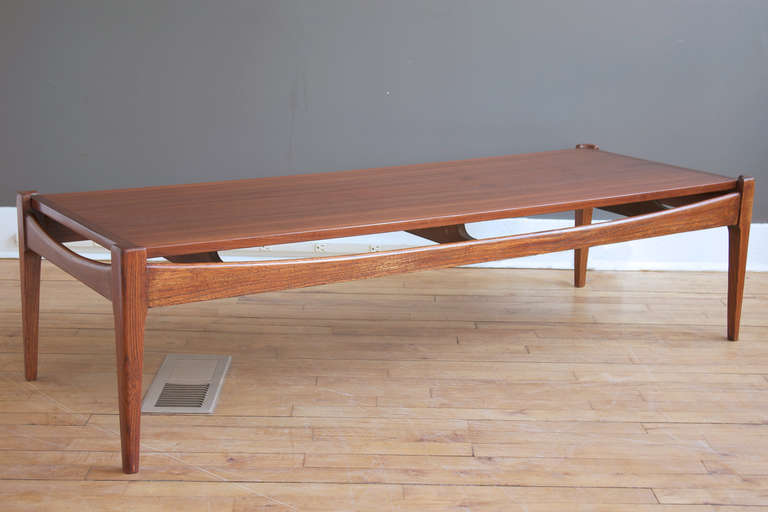 A Mid-Century Modern walnut coffee table by Bassett Furniture, circa 1960.