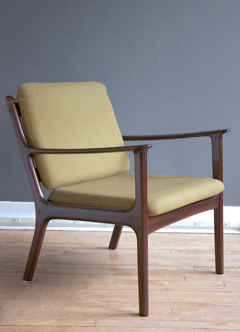A mahogany open frame lounge chair designed by Ole Wanscher, circa 1950.
