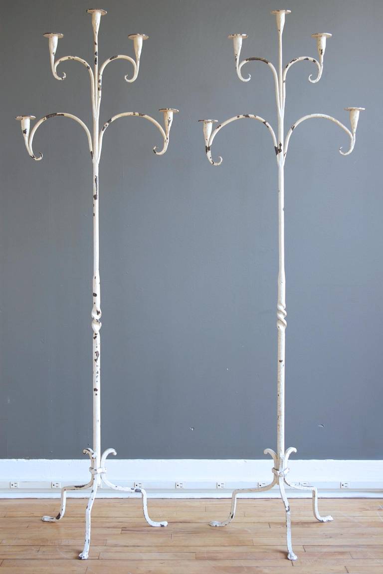 A pair of large antique wrought iron candelabra with distressed white finish, ca. 1900.